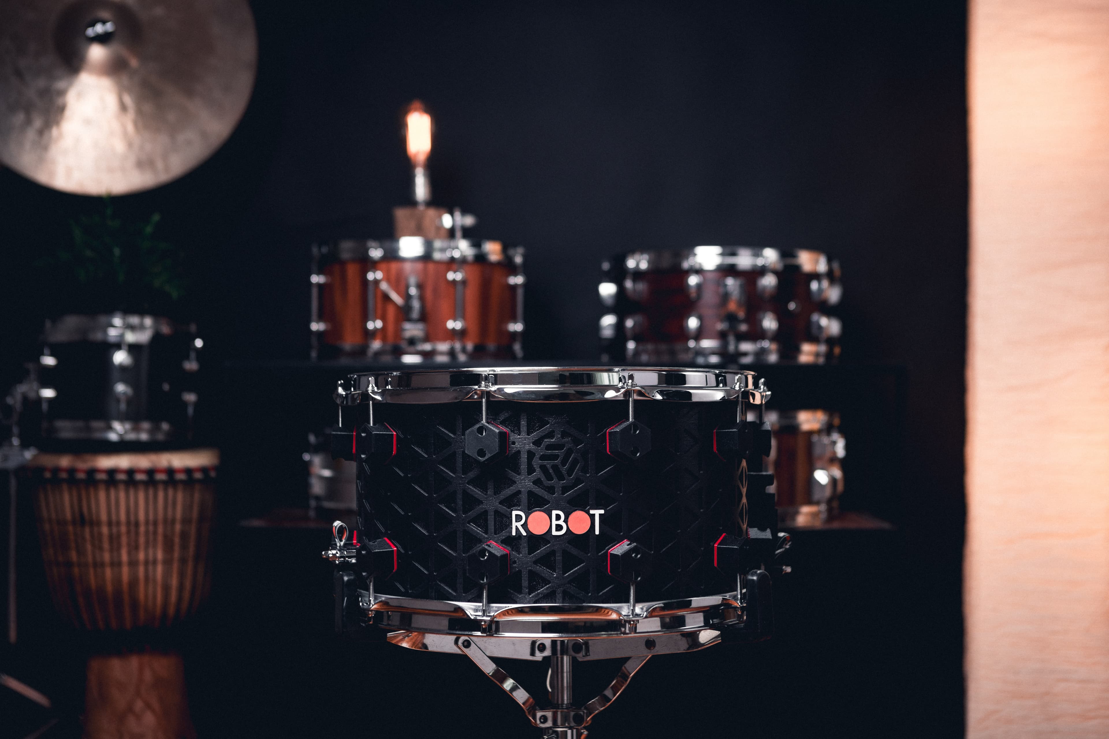 Black Robot drum in a dramatic studio setting.