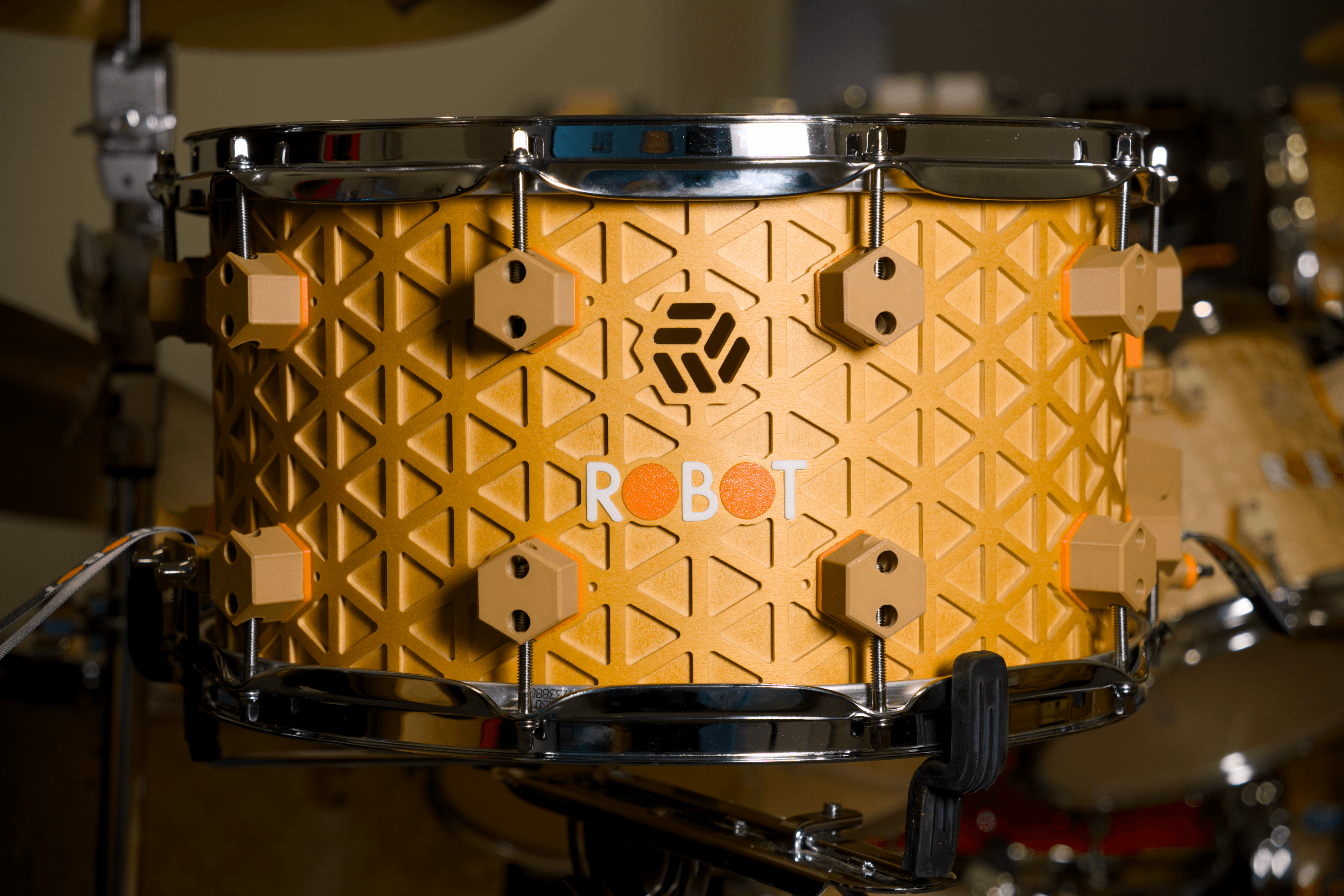 Honey wheat Kumiko Series snare with an isogrid shell and chrome hardware.
